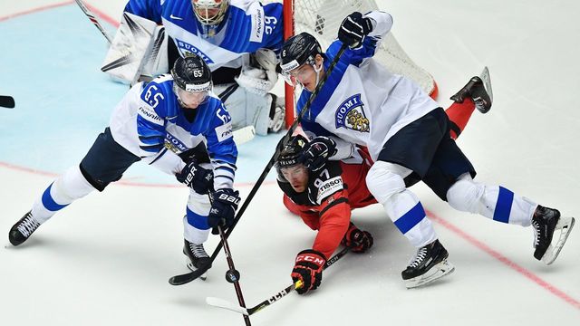 Canada's Connor McDavid (C) fights for the puck with Finland's Sakari Manninen (L) and ulius Honka during the group B match Canada vs Finland of the 2018 IIHF Ice Hockey World Championship at the Jyske Bank Boxen in Herning, Denmark, on May 12, 2018.