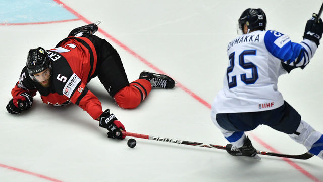 Canada's Aaron Ekblad (L) fights for the puck with Finland's Pekka Jormakka during the group B match Canada vs Finland of the 2018 IIHF Ice Hockey World Championship at the Jyske Bank Boxen in Herning, Denmark, on May 12, 2018.
