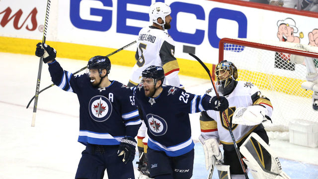 WINNIPEG, MB - MAY 12: Marc-Andre Fleury #29 of the Vegas Golden Knights reacts as Mark Scheifele #55 is congratulated by his teammate Paul Stastny #25 of the Winnipeg Jets after scoring a second period goal in Game One of the Western Conference Finals during the 2018 NHL Stanley Cup Playoffs at Bell MTS Place on May 12, 2018 in Winnipeg, Canada.