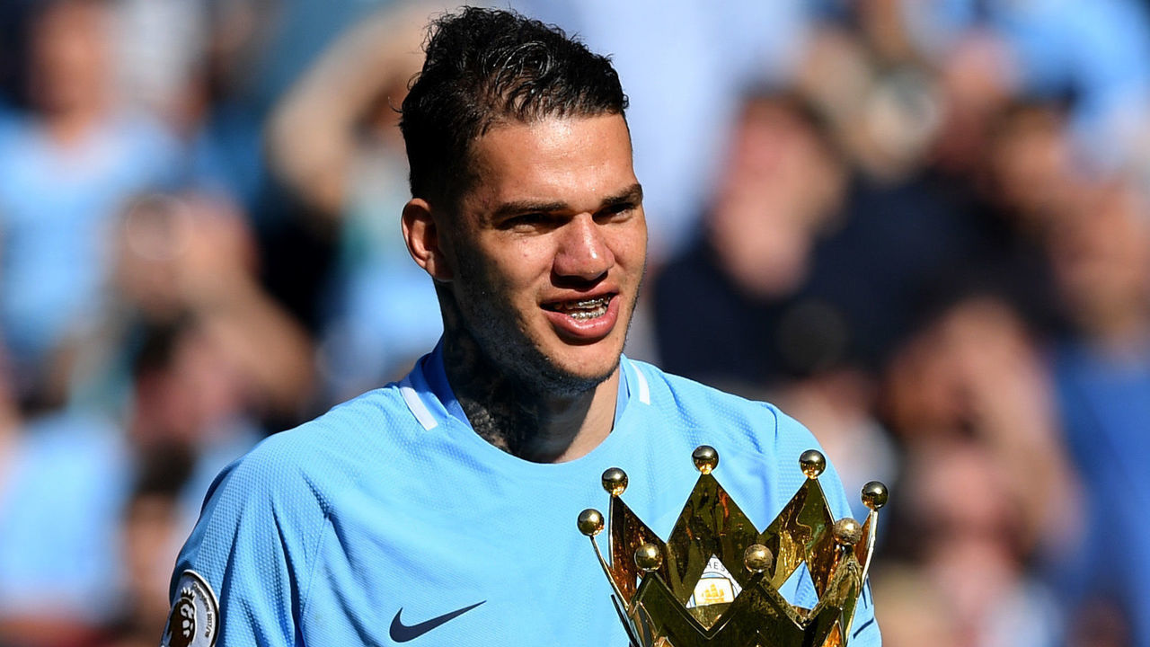 MANCHESTER, ENGLAND - MAY 06: Ederson of Manchester City celebrates with The Premier League Trophy after the Premier League match between Manchester City and Huddersfield Town at Etihad Stadium on May 6, 2018 in Manchester, England.
