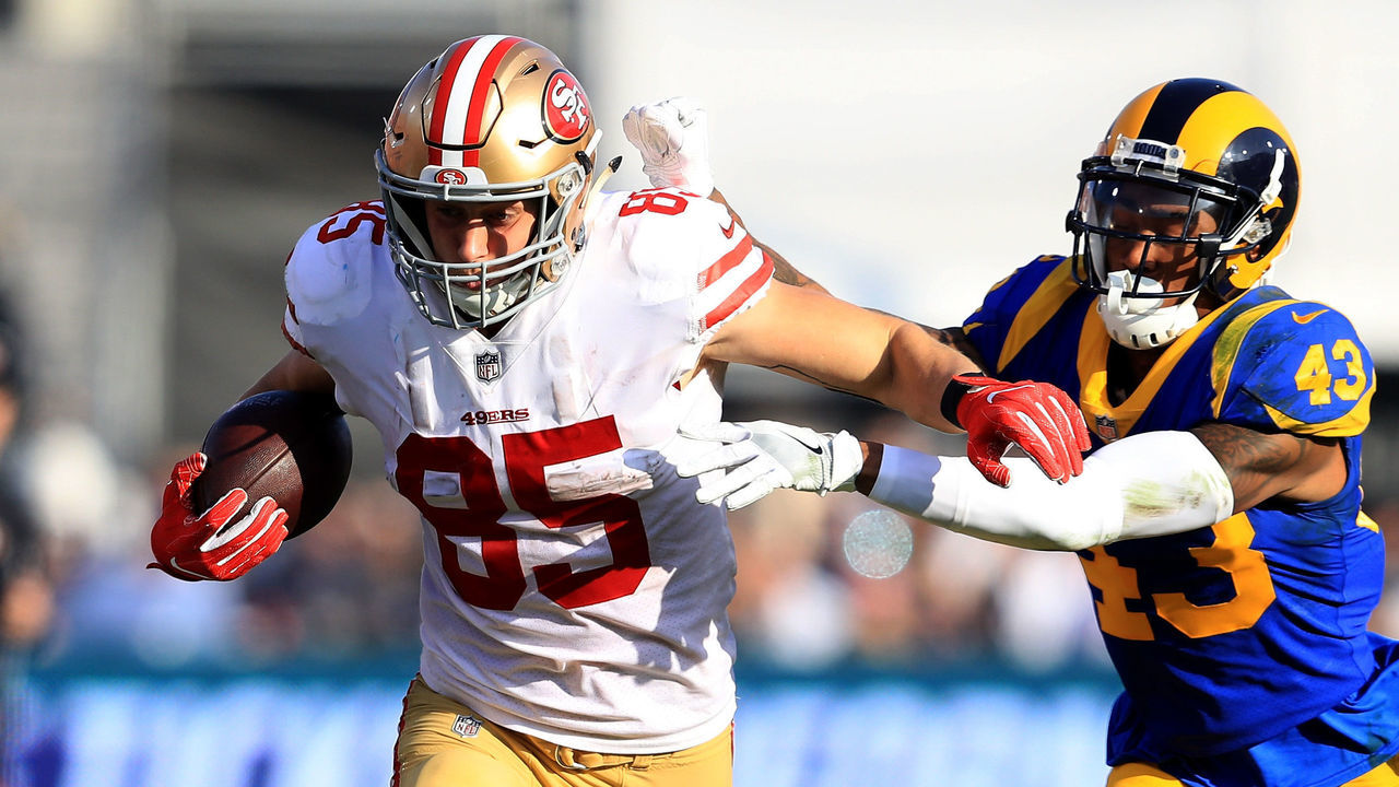LOS ANGELES, CA - DECEMBER 31: George Kittle #85 of the San Francisco 49ers eludes John Johnson #43 of the Los Angeles Rams on a pass play during the first half of a game at Los Angeles Memorial Coliseum on December 31, 2017 in Los Angeles, California.