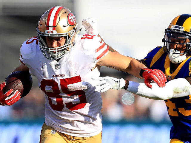 LOS ANGELES, CA - DECEMBER 31: George Kittle #85 of the San Francisco 49ers eludes John Johnson #43 of the Los Angeles Rams on a pass play during the first half of a game at Los Angeles Memorial Coliseum on December 31, 2017 in Los Angeles, California.