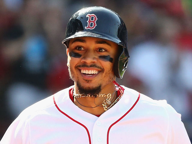 BOSTON, MA - MAY 02: Mookie Betts #50 of the Boston Red Sox celebrates after hitting a solo home run during the seventh inning against the Kansas City Royals at Fenway Park on May 2, 2018 in Boston, Massachusetts.