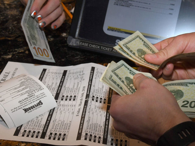 LAS VEGAS, NV - MARCH 15: Jake Sindberg of Wisconsin makes bets during a viewing party for the NCAA Men's College Basketball Tournament inside the 25,000-square-foot Race & Sports SuperBook at the Westgate Las Vegas Resort & Casino which features 4,488-square-feet of HD video screens on March 15, 2018 in Las Vegas, Nevada.