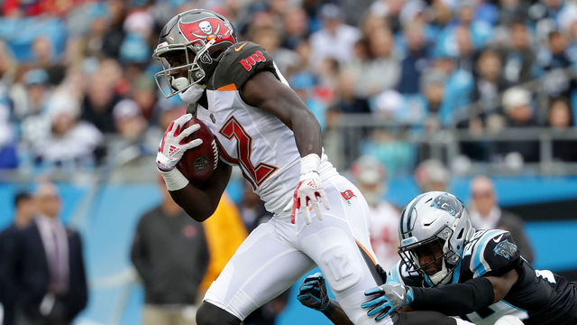 CHARLOTTE, NC - DECEMBER 24: Chris Godwin #12 of the Tampa Bay Buccaneers runs the ball against the Carolina Panthers in the second quarter during their game at Bank of America Stadium on December 24, 2017 in Charlotte, North Carolina.