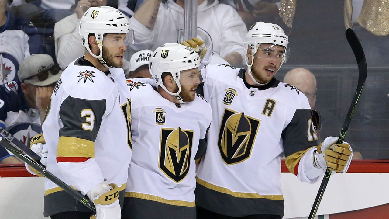 WINNIPEG, MB - MAY 14: Jonathan Marchessault #81 is congratulated by his teammates Brayden McNabb #3 and Reilly Smith #19 of the Vegas Golden Knights after scoring a first period goal against the Winnipeg Jets in Game Two of the Western Conference Finals during the 2018 NHL Stanley Cup Playoffs at Bell MTS Place on May 14, 2018 in Winnipeg, Canada.