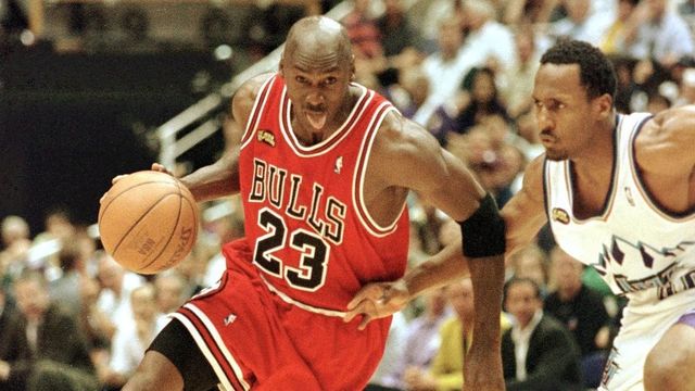 SALT LAKE CITY, UNITED STATES: Michael Jordan (L) of the Chicago Bulls goes to the basket past Shandon Anderson of the Utah Jazz 14 June during game six of the NBA Finals at the Delta Center in Salt Lake City, UT. The Bulls lead the best-of-seven series 3-2. AFP PHOTO/Mike NELSON