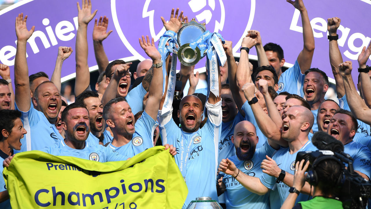 MANCHESTER, ENGLAND - MAY 06: Josep Guardiola, Manager of Manchester City lifts The Premier League Trophy after the Premier League match between Manchester City and Huddersfield Town at Etihad Stadium on May 6, 2018 in Manchester, England.