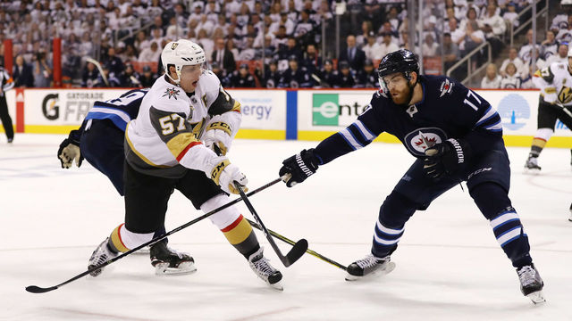 WINNIPEG, MB - MAY 12: David Perron #57 of the Vegas Golden Knights is defended by Adam Lowry #17 of the Winnipeg Jets during the third period in Game One of the Western Conference Finals during the 2018 NHL Stanley Cup Playoffs at Bell MTS Place on May 12, 2018 in Winnipeg, Canada. The Winnipeg Jets defeated the Vegas Golden Knights 4-2.