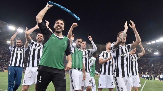 Juventus' goalkeeper from Italy Gianluigi Buffon celebrates with teammates at the end of the Italian Serie A football match AS Roma vs Juventus at the Olympic stadium on May 13, 2018 in Rome. Juventus won a seventh straight Serie A title on Sunday after a goalless draw against ten-man Roma at the Stadio Olimpico. - The Turin giants become the first team to complete the league and Cup double for four consecutive seasons. It is the 34th Scudetto in Juventus's history.