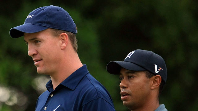 CHARLOTTE, NC - APRIL 29: NFL player Peyton Manning waits alongside Tiger Woods on a green during the Pro-Am prior to the start of the Quail Hollow Championship at the Quail Hollow Club on April 29, 2009 in Charlotte, North Carolina.
