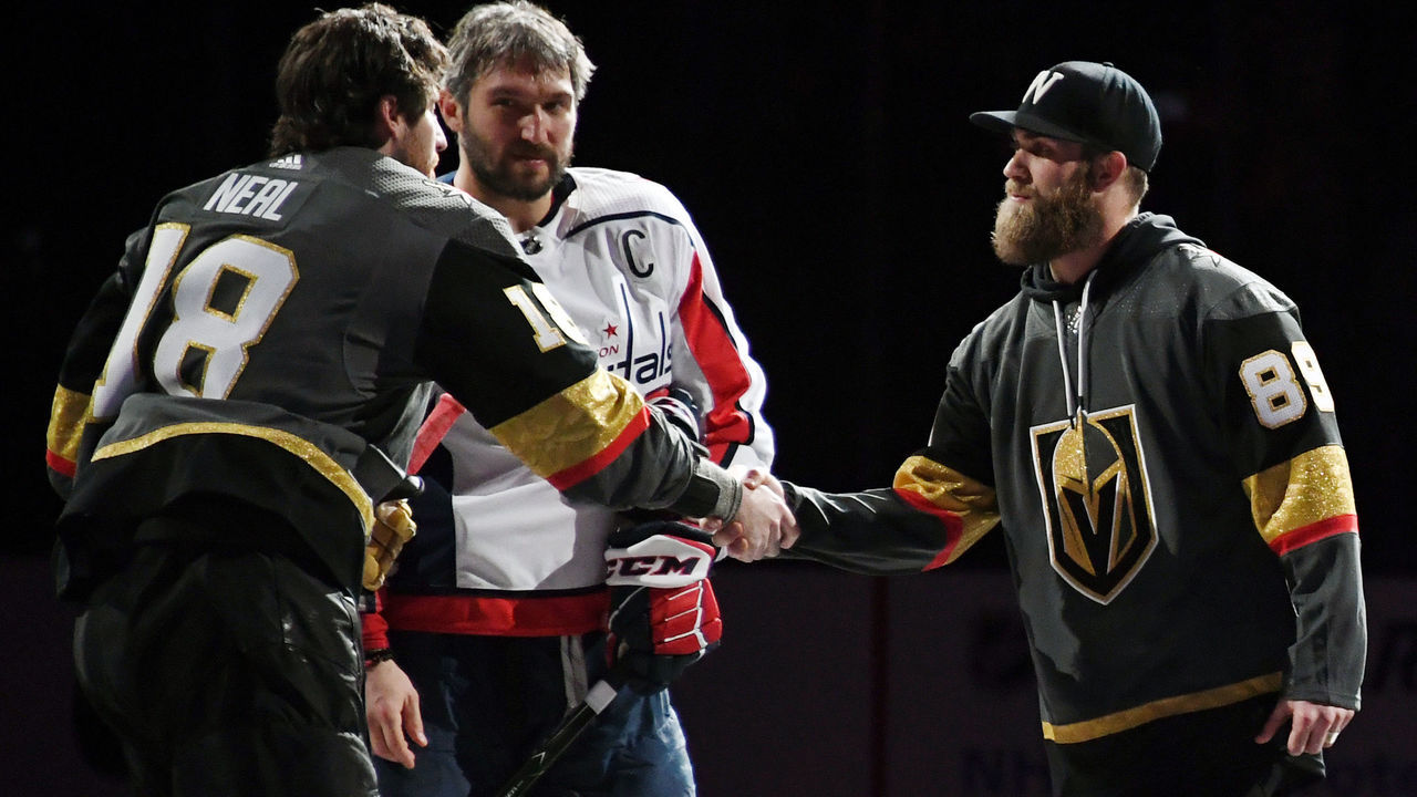 LAS VEGAS, NV - DECEMBER 23: (L-R) James Neal #18 of the Vegas Golden Knights and Alex Ovechkin #8 of the Washington Capitals shake hands with Washington Nationals outfielder Bryce Harper after he came out to do the ceremonial puck drop before their game at T-Mobile Arena on December 23, 2017 in Las Vegas, Nevada.
