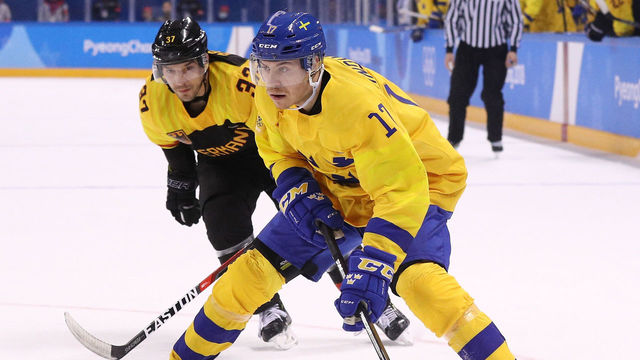 GANGNEUNG, SOUTH KOREA - FEBRUARY 21: Par Lindholm #17 of Sweden controls the puck against Patrick Reimer #37 of Germany during the Men's Play-offs Quarterfinals game on day twelve of the PyeongChang 2018 Winter Olympic Games at Kwandong Hockey Centre on February 21, 2018 in Gangneung, South Korea.