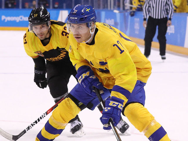 GANGNEUNG, SOUTH KOREA - FEBRUARY 21: Par Lindholm #17 of Sweden controls the puck against Patrick Reimer #37 of Germany during the Men's Play-offs Quarterfinals game on day twelve of the PyeongChang 2018 Winter Olympic Games at Kwandong Hockey Centre on February 21, 2018 in Gangneung, South Korea.