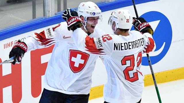 Switzerland's Enzo Corvi (L) celebrates his goal with his teamamte Nino Niederreiter during the quarterfinal match Finland vs Switzerland of the 2018 IIHF Ice Hockey World Championship at the Jyske Bank Boxen in Herning, Denmark, on May 17, 2018.