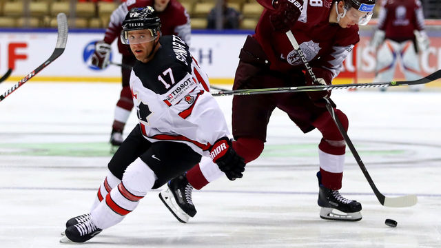 HERNING, DENMARK - MAY 14: Jaden Schwartz (L) of Canada and Rodrigo Abols of Latvia battle for the puck during the 2018 IIHF Ice Hockey World Championship Group B game between Canada and Latvia at Jyske Bank Boxen on May 14, 2018 in Herning, Denmark.