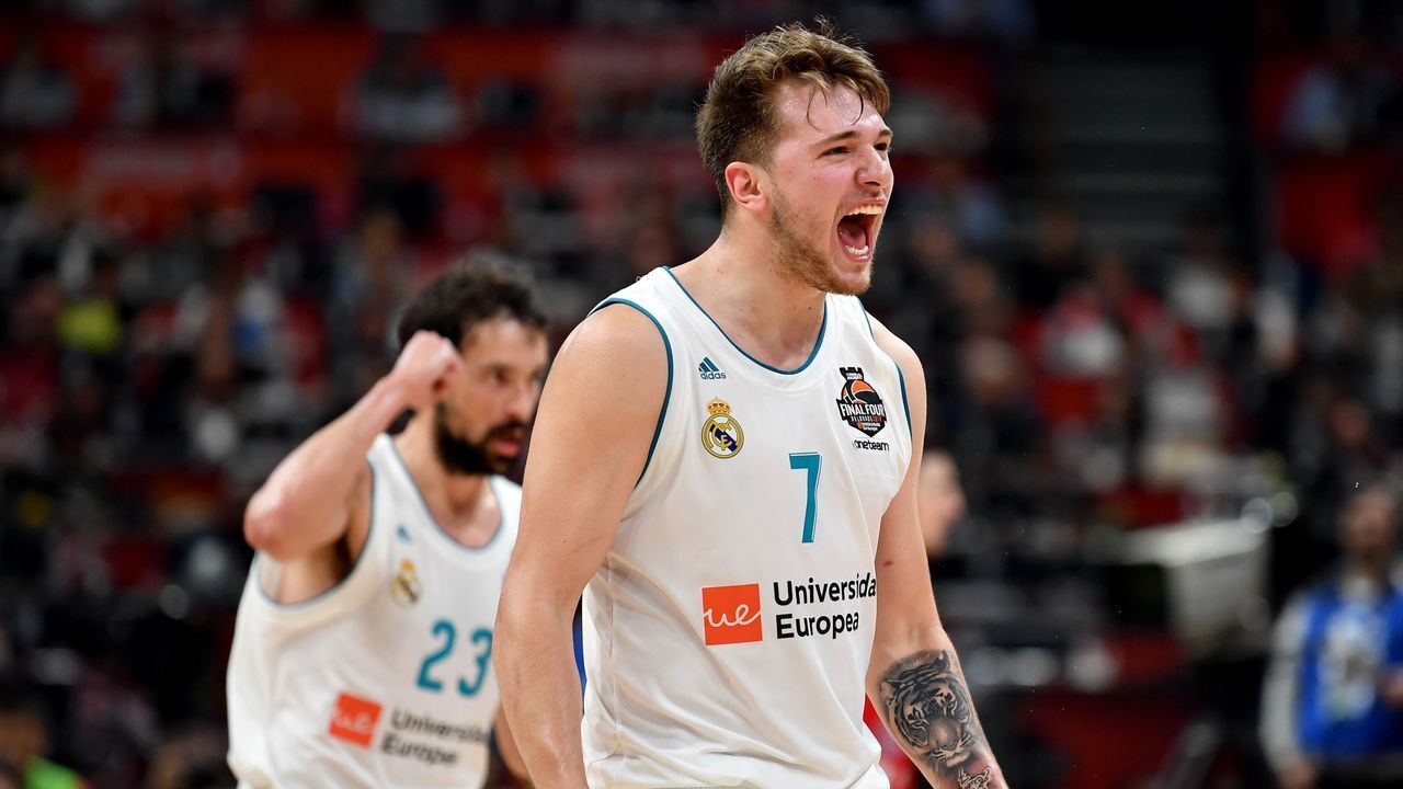 Real Madrid's Slovenian Luka Doncic (R) and Real Madrid's Spanish guard Sergio Llull react after scoring a point during the Euroleague Final Four second semi-final match between CSKA Moscow and Real Madrid at The Stark Arena in Belgrade on May 18, 2018.