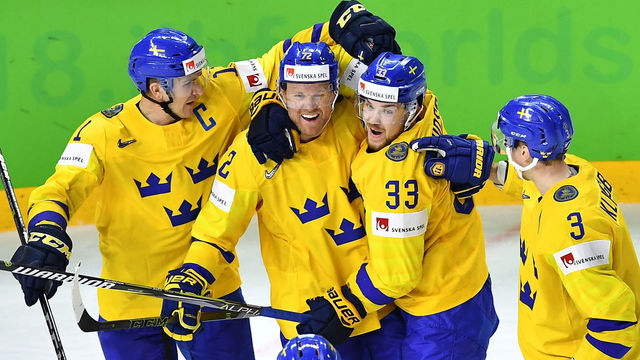 Sweden's players celebrate during the semifinal match Sweden vs USA of the 2018 IIHF Ice Hockey World Championship at the Royal Arena in Copenhagen, Denmark, on May 19, 2018.