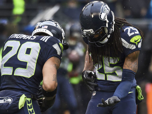 SEATTLE, WA - DECEMBER 27: Free safety Earl Thomas #29 and cornerback Richard Sherman #25 of the Seattle Seahawks play a little air guitar before the game against the St. Louis Rams at CenturyLink Field on December 27, 2015 in Seattle,Washington.