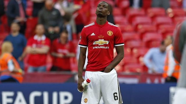 Manchester United's French midfielder Paul Pogba reacts to their defeat on the pitch after the English FA Cup final football match between Chelsea and Manchester United at Wembley stadium in London on May 19, 2018. - Chelsea beat Manchester United 1-0 to lift the FA Cup thanks to Eden Hazard's penalty at Wembley on Saturday to salvage a disappointing season.