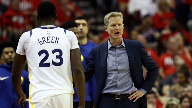HOUSTON, TX - MAY 14: Head coach Steve Kerr of the Golden State Warriors reacts in the first half as Draymond Green #23 walks to the bench against the Houston Rockets in Game One of the Western Conference Finals of the 2018 NBA Playoffs at Toyota Center on May 14, 2018 in Houston, Texas.
