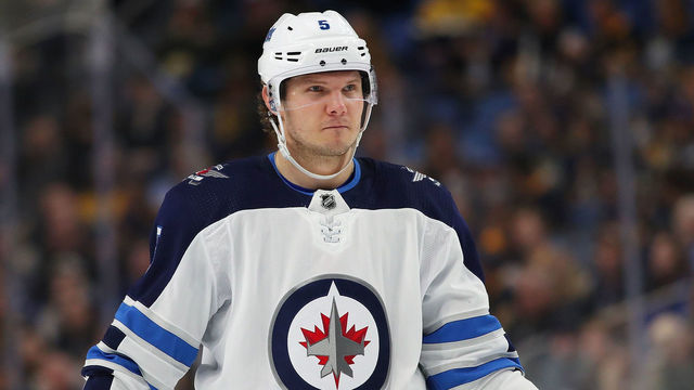 BUFFALO, NY - JANUARY 9: Dmitry Kulikov #5 of the Winnipeg Jets in play against the Buffalo Sabres at the KeyBank Center on January 9, 2018 in Buffalo, New York. The Jets beat the Sabres 7-4.