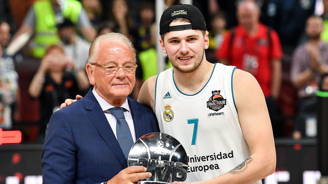 Real Madrid's Slovenian Luka Doncic poses for a photograph with the team's President Florentino Perez as they celebrate their 85-80 win over Fenerbahce in the Euroleague Final Four finals basketball match between Real Madrid and Fenerbahce Dogus Istanbul at The Stark Arena in Belgrade on May 20, 2018.