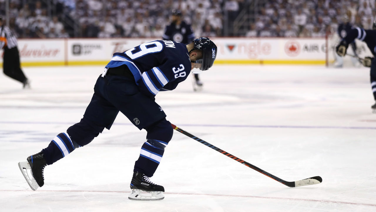 WINNIPEG, MB - MAY 12: Toby Enstrom #39 of the Winnipeg Jets reacts after being knocked down to the ice against the Vegas Golden Knights during the second period in Game One of the Western Conference Finals during the 2018 NHL Stanley Cup Playoffs at Bell MTS Place on May 12, 2018 in Winnipeg, Canada.