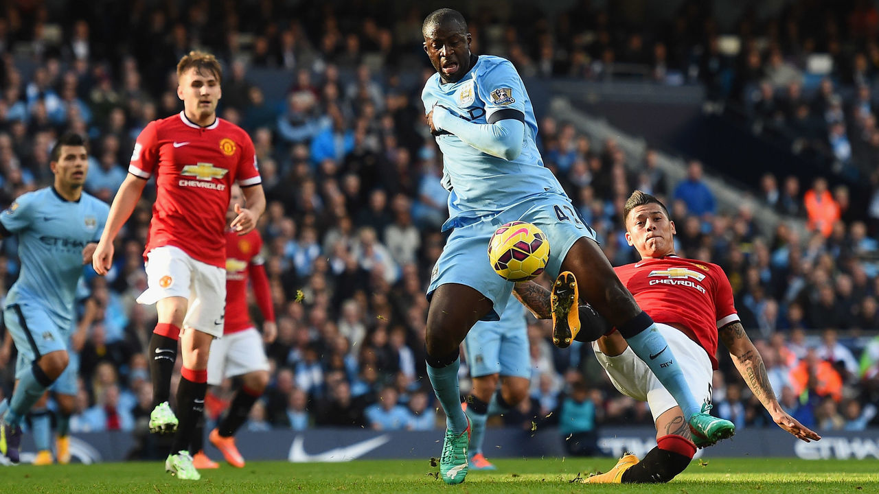 MANCHESTER, ENGLAND - NOVEMBER 02: Yaya Toure of Manchester City goes down in the area after a challenge from Marcos Rojo of Manchester United during the Barclays Premier League match between Manchester City and Manchester United at Etihad Stadium on November 2, 2014 in Manchester, England.