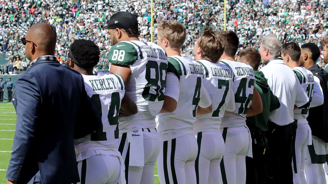 EAST RUTHERFORD, NJ - OCTOBER 01: Members of the New York Jets link arms during the national anthem before taking on the Jacksonville Jaguars at MetLife Stadium on October 1, 2017 in East Rutherford, New Jersey.