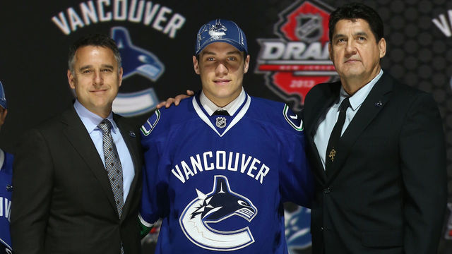 NEWARK, NJ - JUNE 30: Bo Horvat (C) poses with Laurence Gilman (L), Vice President Hockey Operations and Assistant General Manager, and Ron Delorme (R), Chief Amateur Scout after being selected number nine overall in the first round by the Vancouver Canucks during the 2013 NHL Draft at the Prudential Center on June 30, 2013 in Newark, New Jersey.