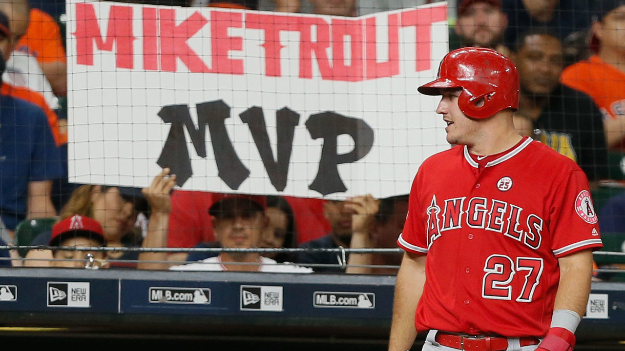 HOUSTON, TX - SEPTEMBER 24: A Los Angeles Angels of Anaheim fan holds up a sign as Mike Trout #27 of the Los Angeles Angels of Anaheim talks to the dugout between pitches against the Houston Astros at Minute Maid Park on September 24, 2017 in Houston, Texas.