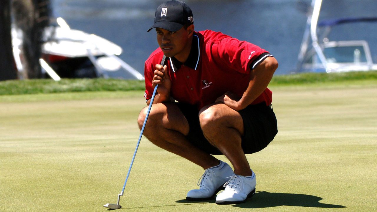 Tiger Woods, wearing shorts, lines up a putt on the second hole during competition in the 2005 Tavistock Cup at Isleworth Country Club March 29.