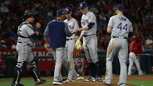 ANAHEIM, CA - MAY 19: Pitcher Ryan Yarbrough #48 of the Tampa Bay Rays hands the to manager Kevin Cash before leaving the game in the eighth inning during the MLB game against the Los Angeles Angels of Anaheim at Angel Stadium on May 19, 2018 in Anaheim, California.