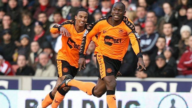 Wigan Athletic's Maynor Figueroa (right) celebrates scoring from a free-kick in his own half to put his side 2-1 up