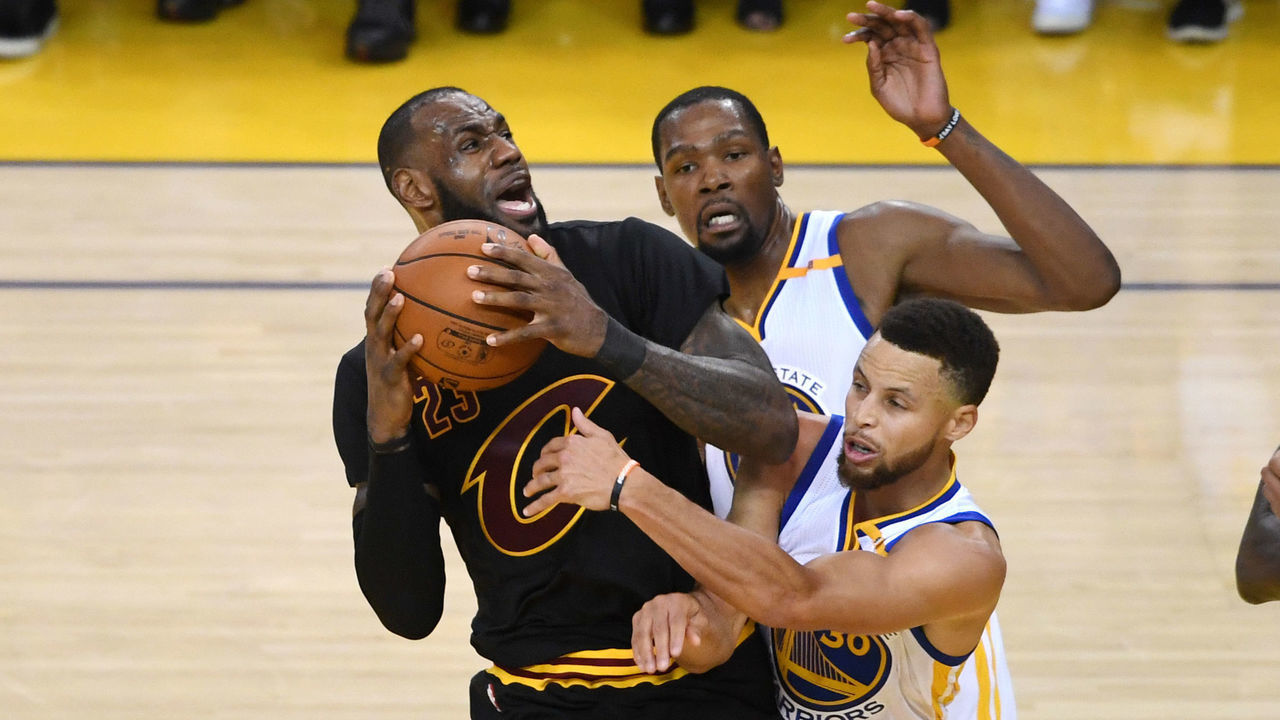 OAKLAND, CA - JUNE 12: LeBron James #23 of the Cleveland Cavaliers is defended by Kevin Durant #35 and Stephen Curry #30 of the Golden State Warriors during the second half in Game 5 of the 2017 NBA Finals at ORACLE Arena on June 12, 2017 in Oakland, California.
