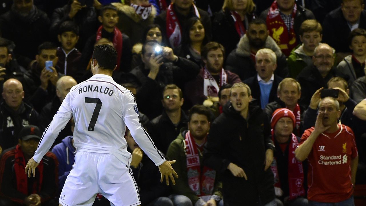 Real Madrid's Portuguese forward Cristiano Ronaldo celebrates in front of the home fans after scoring the opening goal during the UEFA Champions League, group B, football match between Liverpool and Real Madrid at Anfield in Liverpool, northwest England, on October 22, 2014. AFP PHOTO / PIERRE-PHILIPPE MARCOU