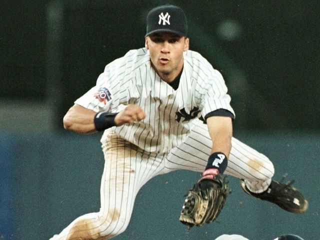 NEW YORK, UNITED STATES: New York Yankee shortstop Derek Jeter jumps to avoid a sliding Brian Giles of the Cleveland Indians as Giles is forced out at second base in the third inning of their game 27 June at Yankee Stadium in New York. Jeter's throw to first base got the Indians' Omar Vizquel out to complete the double play. AFP PHOTO/STAN HONDA