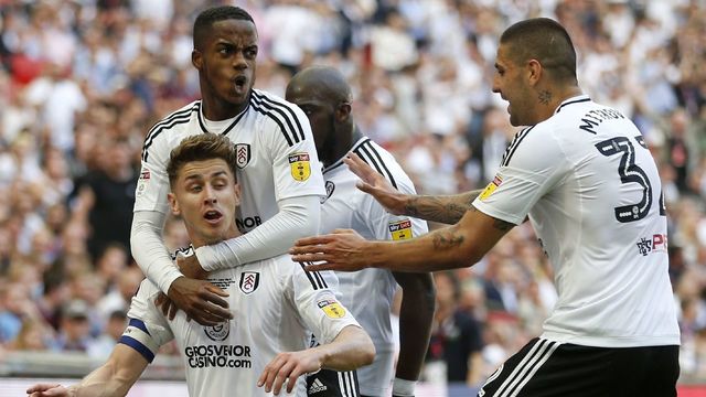 Fulham's English midfielder Tom Cairney (L) celebrates with Fulham's English defender Ryan Sessegnon (2nd L) and Fulham's Serbian striker Aleksandar Mitrovic (R) after scoring the opening goal of the English Championship play-off final football match between Aston Villa and Fulham at Wembley Stadium in London on May 26, 2018.