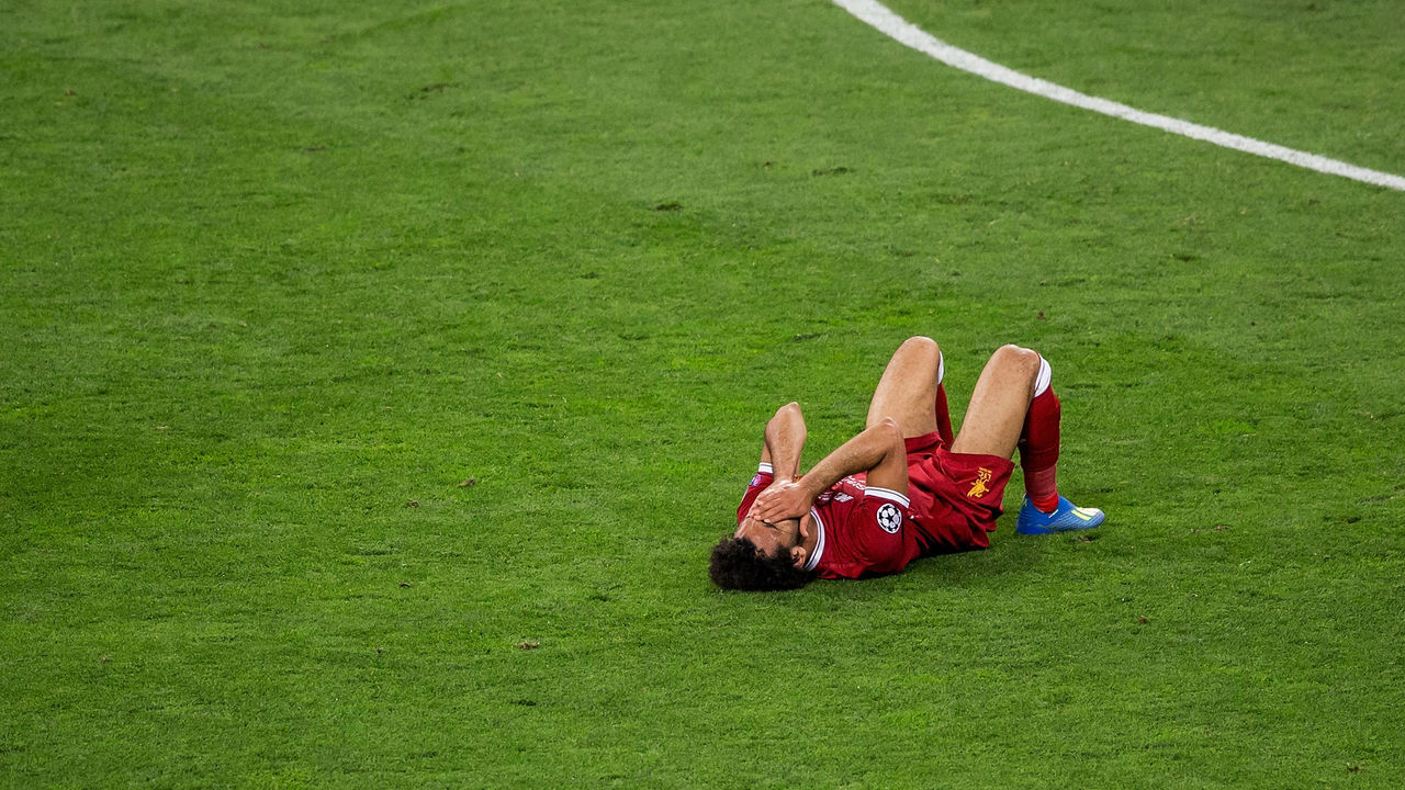 KIEV, UKRAINE - MAY 26: Mohamed Salah of Liverpool reacts after colliding with Sergio Ramos of Real Madrid during the UEFA Champions League final between Real Madrid and Liverpool on May 26, 2018 in Kiev, Ukraine.