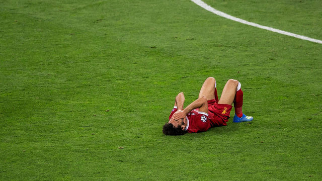 KIEV, UKRAINE - MAY 26: Mohamed Salah of Liverpool reacts after colliding with Sergio Ramos of Real Madrid during the UEFA Champions League final between Real Madrid and Liverpool on May 26, 2018 in Kiev, Ukraine.