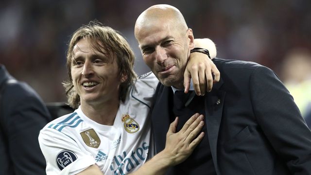 Real Madrid's French coach Zinedine Zidane (R) and Real Madrid's Croatian midfielder Luka Modric celebrate after winning the UEFA Champions League final football match between Liverpool and Real Madrid at the Olympic Stadium in Kiev, Ukraine on May 26, 2018.