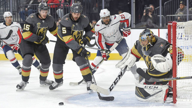 LAS VEGAS, NV - DECEMBER 23: (L-R) Jon Merrill #15, Deryk Engelland #5, and Marc-Andre Fleury #29 of the Vegas Golden Knights defend against Devante Smith-Pelly #25 of the Washington Capitals during the game at T-Mobile Arena on December 23, 2017 in Las Vegas, Nevada.