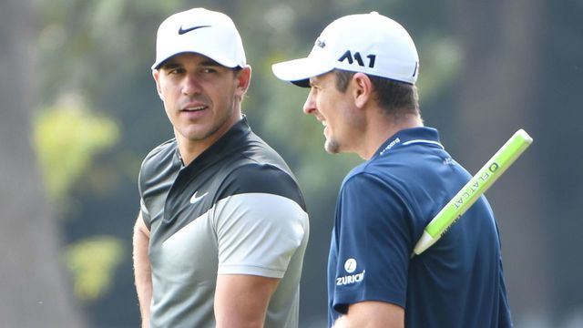 Justin Rose (R) of England chats with Brooks Koepka of the US as they wait to tee off during the third round of the WGC-HSBC Champions at the Sheshan International golf club in Shanghai on October 28, 2017. / AFP PHOTO / GOH CHAI HIN