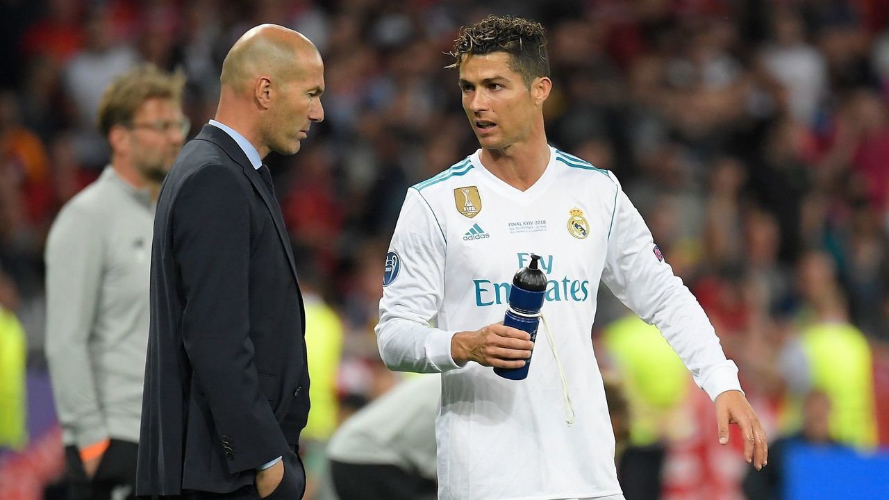 Real Madrid's French coach Zinedine Zidane (L) talks to Real Madrid's Portuguese forward Cristiano Ronaldo during the UEFA Champions League final football match between Liverpool and Real Madrid at the Olympic Stadium in Kiev, Ukraine on May 26, 2018.