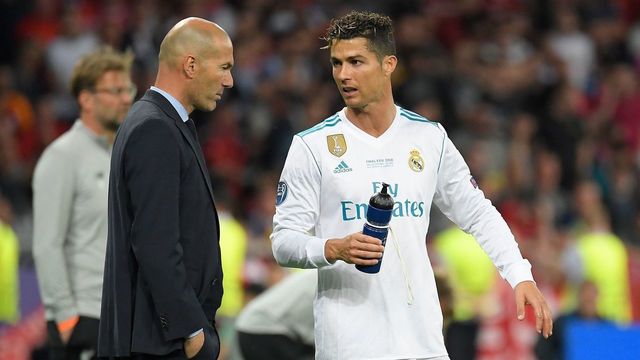 Real Madrid's French coach Zinedine Zidane (L) talks to Real Madrid's Portuguese forward Cristiano Ronaldo during the UEFA Champions League final football match between Liverpool and Real Madrid at the Olympic Stadium in Kiev, Ukraine on May 26, 2018.