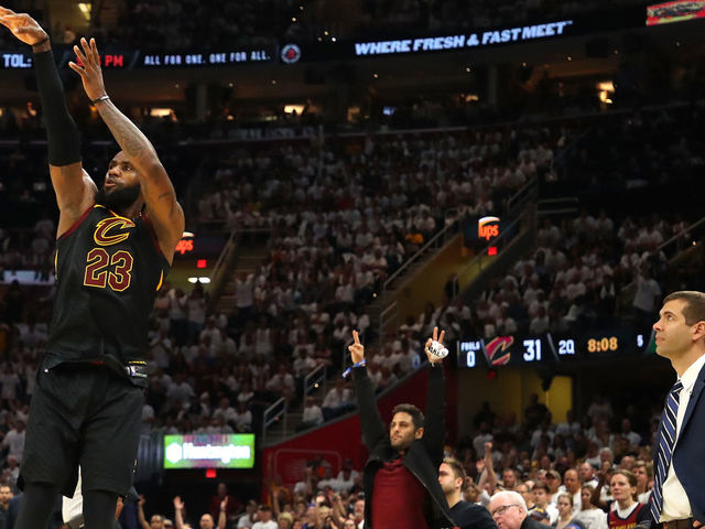 CLEVELAND, OH - MAY 25: LeBron James of the Cleveland Cavaliers shoots against Marcus Morris of the Boston Celtics in the second quarter as head coach Brad Stevens of the Boston Celtics looks on during Game Six of the 2018 NBA Eastern Conference Finals at Quicken Loans Arena on May 25, 2018 in Cleveland, Ohio.