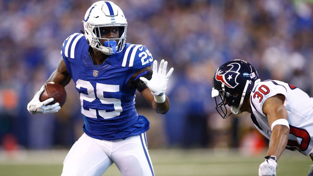 INDIANAPOLIS, IN - DECEMBER 31: Marlon Mack #25 of the Indianapolis Colts pushes off a tackle from Kevin Johnson #30 of the Houston Texans during the second half at Lucas Oil Stadium on December 31, 2017 in Indianapolis, Indiana.