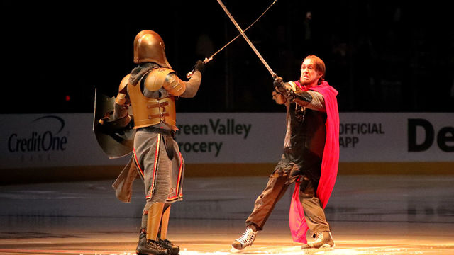 LAS VEGAS, NV - MAY 28: The Golden Knight performs with the Washington Capitals swordsman prior to Game One of the 2018 NHL Stanley Cup Final between the Vegas Golden Knights and the Washington Capitals at T-Mobile Arena on May 28, 2018 in Las Vegas, Nevada.