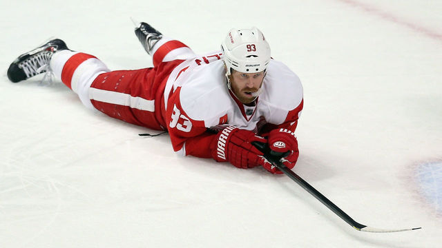 CHICAGO, IL - MARCH 16: Johan Franzen #93 of the Detroit Red Wings lays on the ice after Jonathan Toews of the Chicago Blackhawks scored a short-handed goal in the third period at the United Center on March 16, 2014 in Chicago, Illinois. The Blackhawks defeated the Red Wings 4-1.